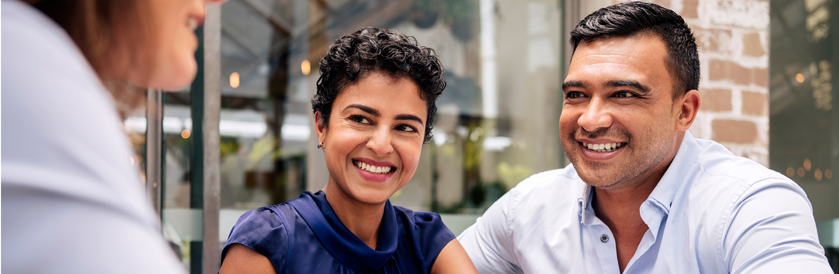 Happy couple talking with a financial advisor