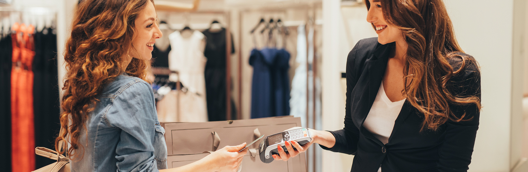 Smiling woman using credit card in a store