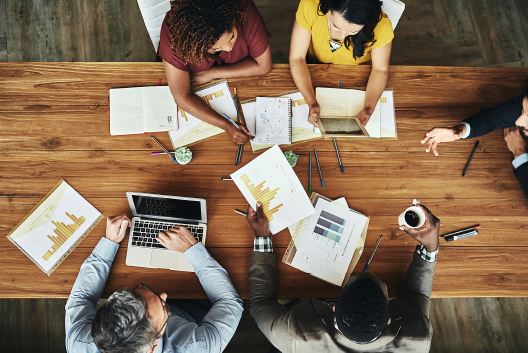 Picture of team working around a table