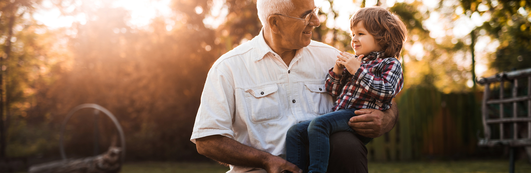 Smiling grandfather holding grandson