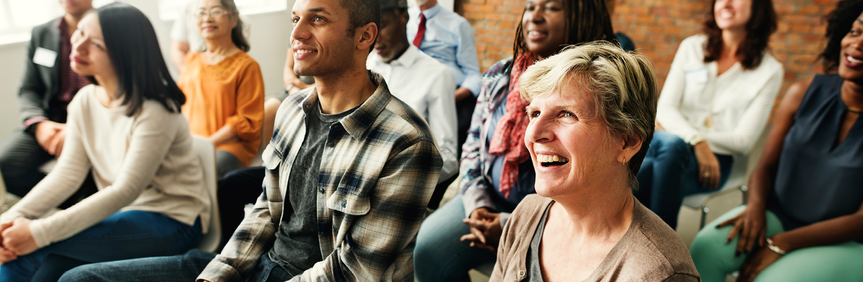 Small happy group of people attending financial seminar