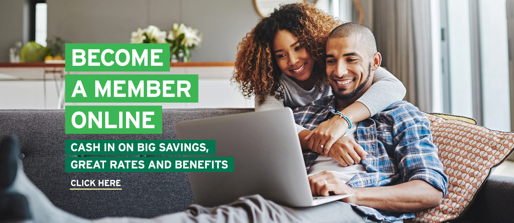 Happy couple at home using a laptop to join Liberty Savings online